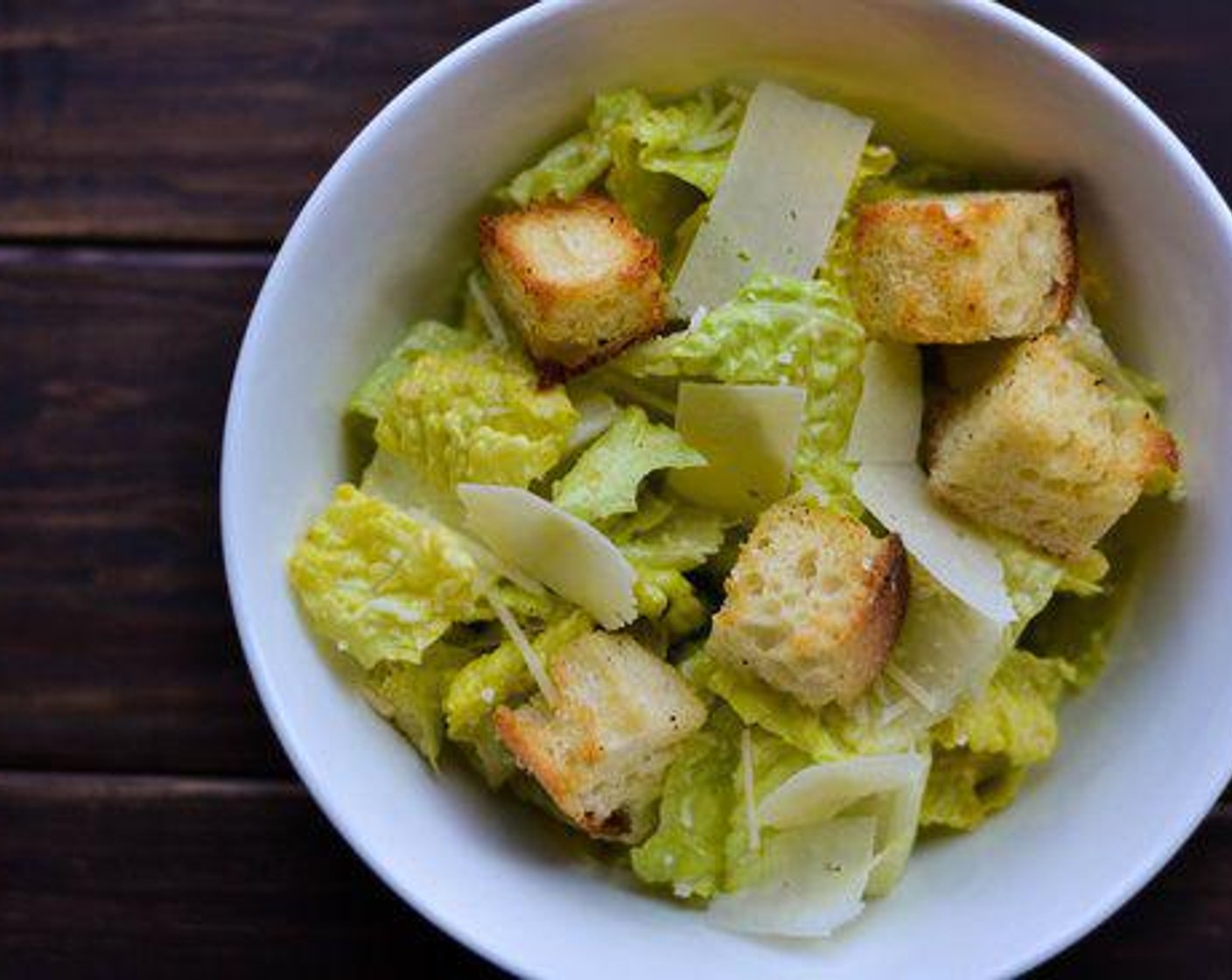step 5 Toss in Romaine Lettuce (1 head) with the dressing. Garnish with croutons, Parmesan Cheese (to taste) and Ground Black Pepper (1 dash).
