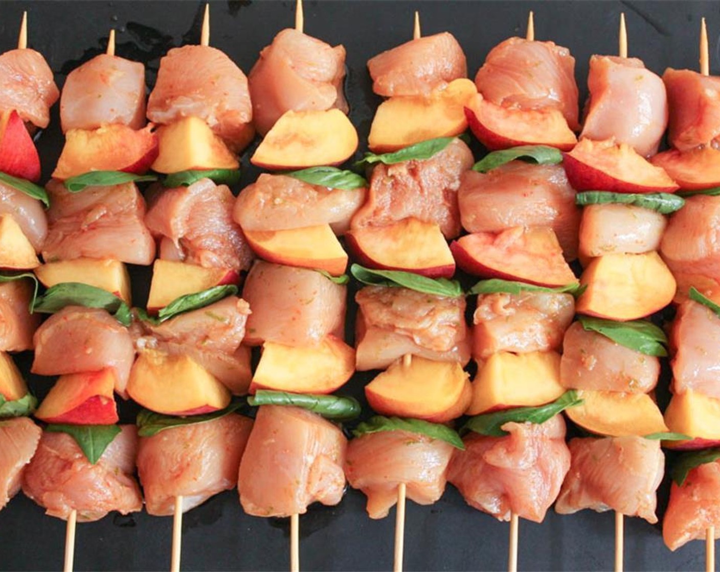 step 7 Repeat this pattern about 3 times per skewer. You should be able to get 4 pieces of chicken, 3 peaches, and 3 leaves of basil on each skewer, but you can do less if you prefer.