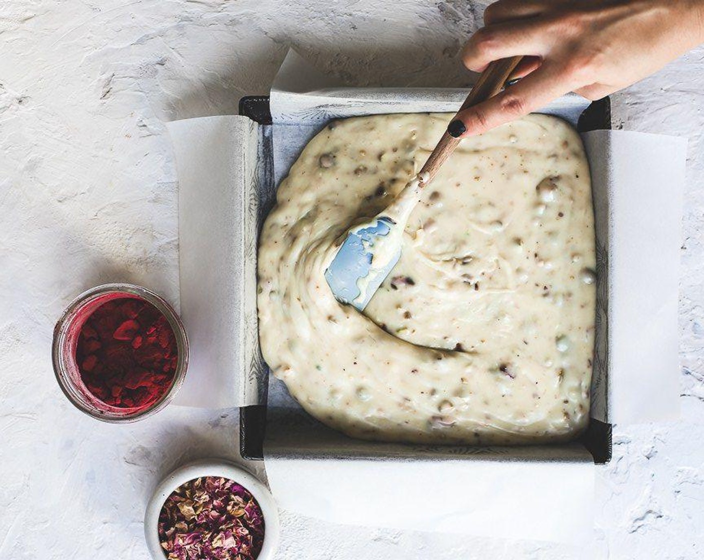 step 3 Once the chocolate chips have melted completely, pour into a 8x8 or 9x9-inch pan lined with parchment paper. Top with additional pistachios, rose petals and salt if desired.