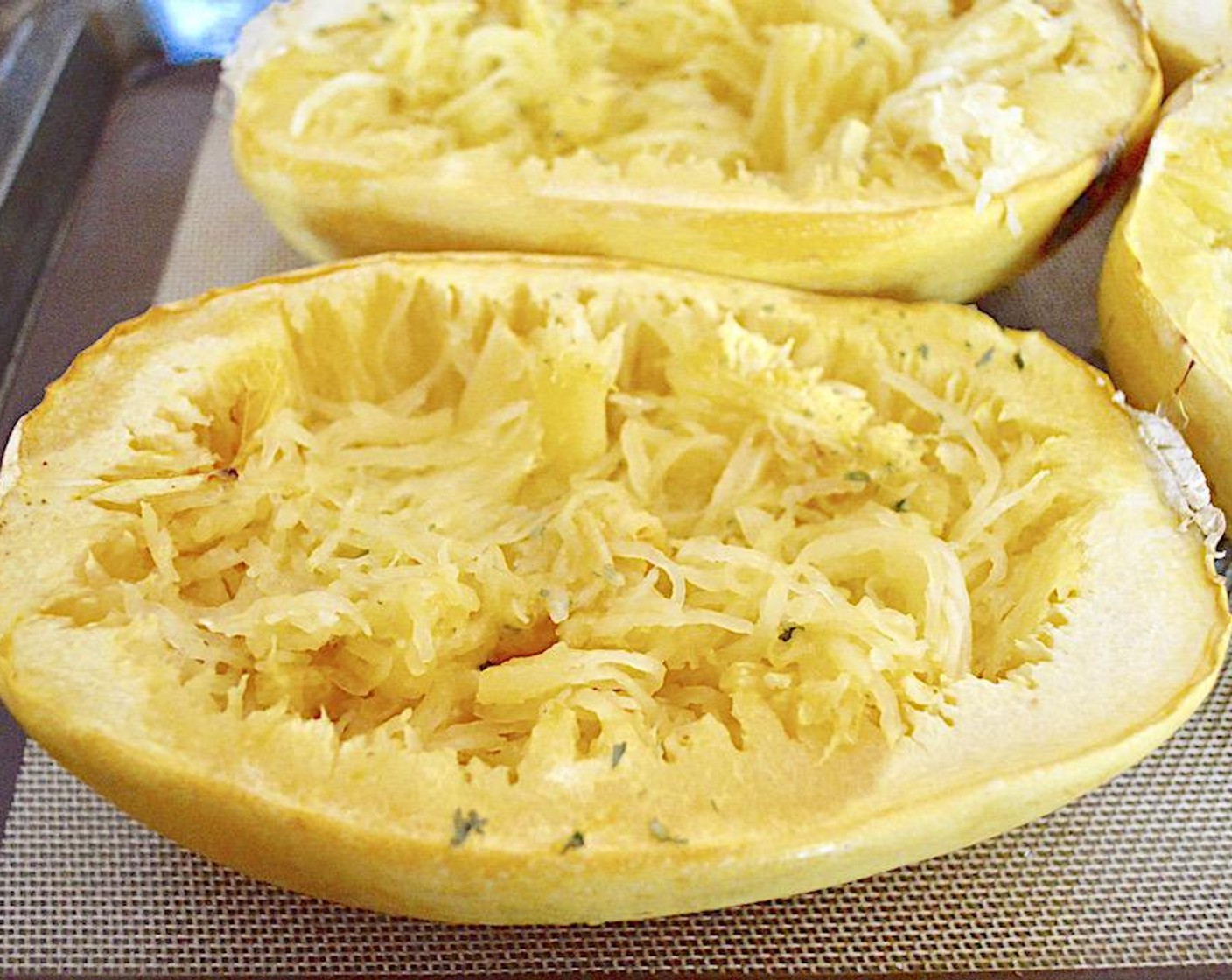 step 5 When the squash is done, take it out and reduce the oven temperature to 350 degrees F (180 degrees C). Use a fork to completely shred the flesh of the squash into tender "spaghetti," leaving it in its shell.