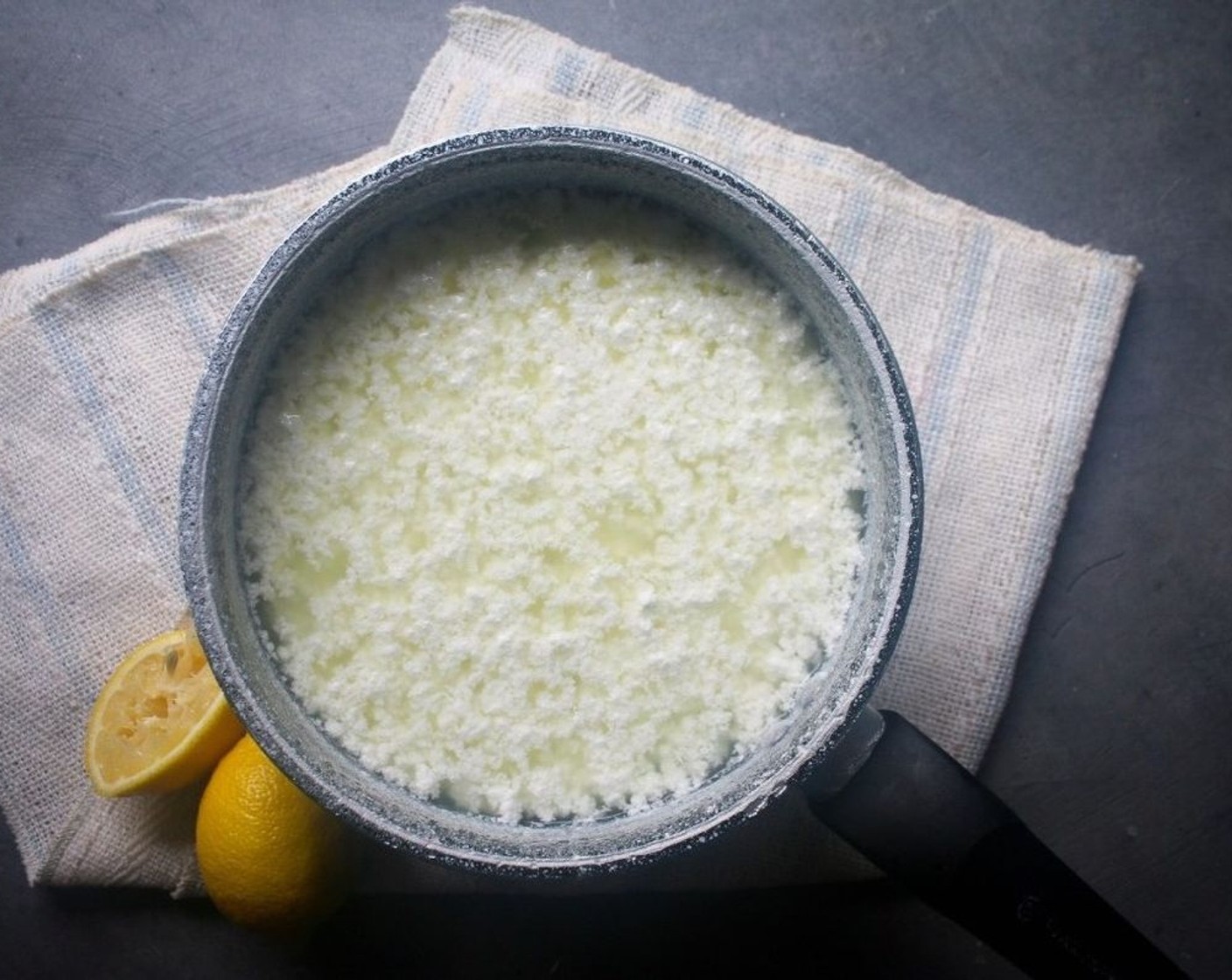 step 2 After 10 minutes, the cheese and whey should be separated into a clear yellow-y liquid and white cheese. If it isn't separated, add an additional tablespoon of lemon juice and stir.