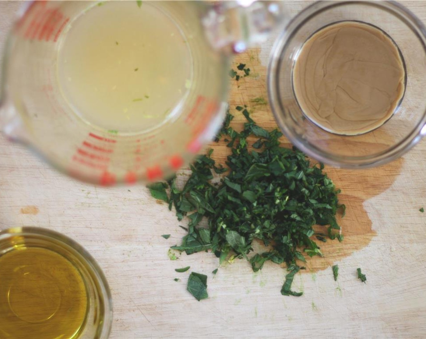 step 5 Make the lemon-mint dressing by combining the Olive Oil (2 Tbsp), Tahini (2 Tbsp), 1/2 of the chopped mint leaves, lemon juice, Salt (1/4 tsp) and Ground Black Pepper (1/2 tsp) in a blender.  Blend until smooth.