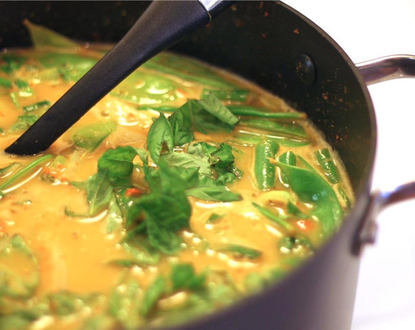 step 8 Bring to a simmer. Add the remaining basil last.