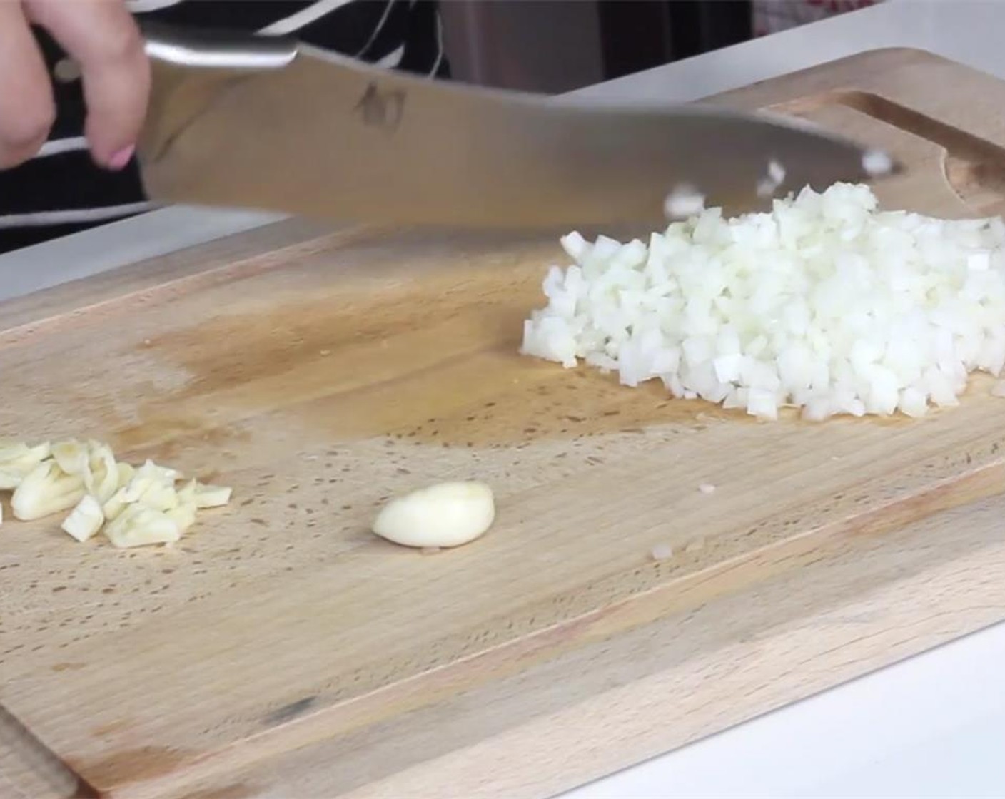 step 1 Finely mince your Garlic (3 cloves) and finely dice your Onion (1).
