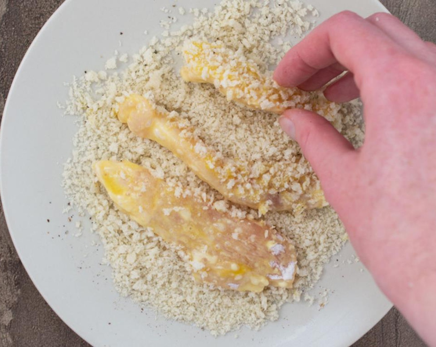 step 6 Coat the chicken tenders in the panko breadcrumbs, making sure to cover them completely.