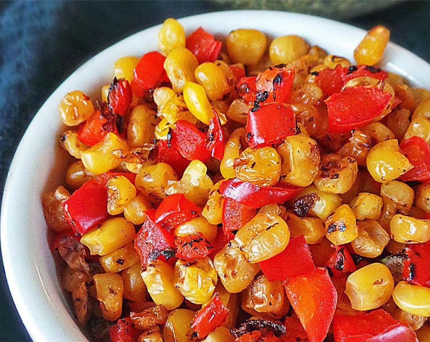 step 4 Place a grill pan over the stove and crank the heat to medium-high. Add the Corn (75 g) and Red Bell Pepper (1) and cook 5 minutes, flipping around the pan until charred.