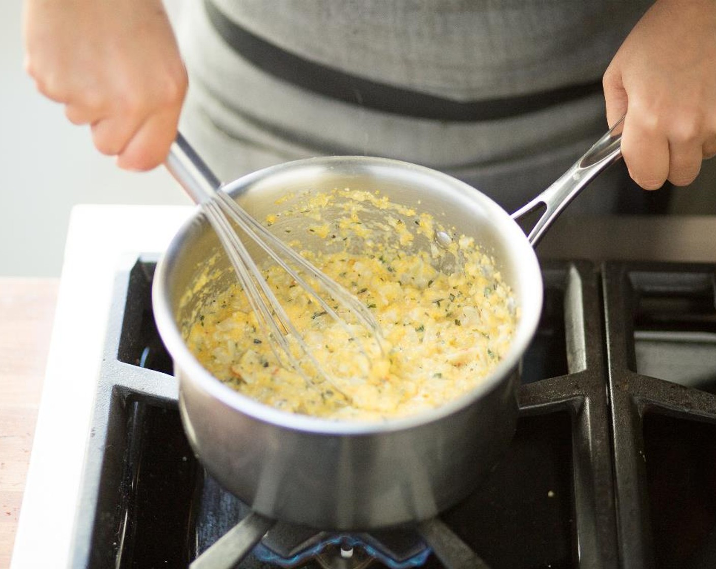step 9 While whisking constantly, add Polenta (2/3 cup) in a slow, steady stream.