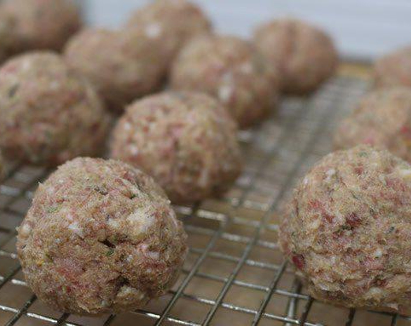 step 1 Combine Ground Italian Sausage (1 lb), 80/20 Lean Ground Beef (1 lb), Eggs (2), Breadcrumbs (1 cup), Grated Parmesan Cheese (1/2 cup), Italian Seasoning (1/2 Tbsp), Granulated Garlic (1 tsp) and Crushed Red Pepper Flakes (1/2 tsp) together in a large bowl with wet hands (or gloves). Once all ingredients are well combined, roll into balls that are about the size of a golf ball.