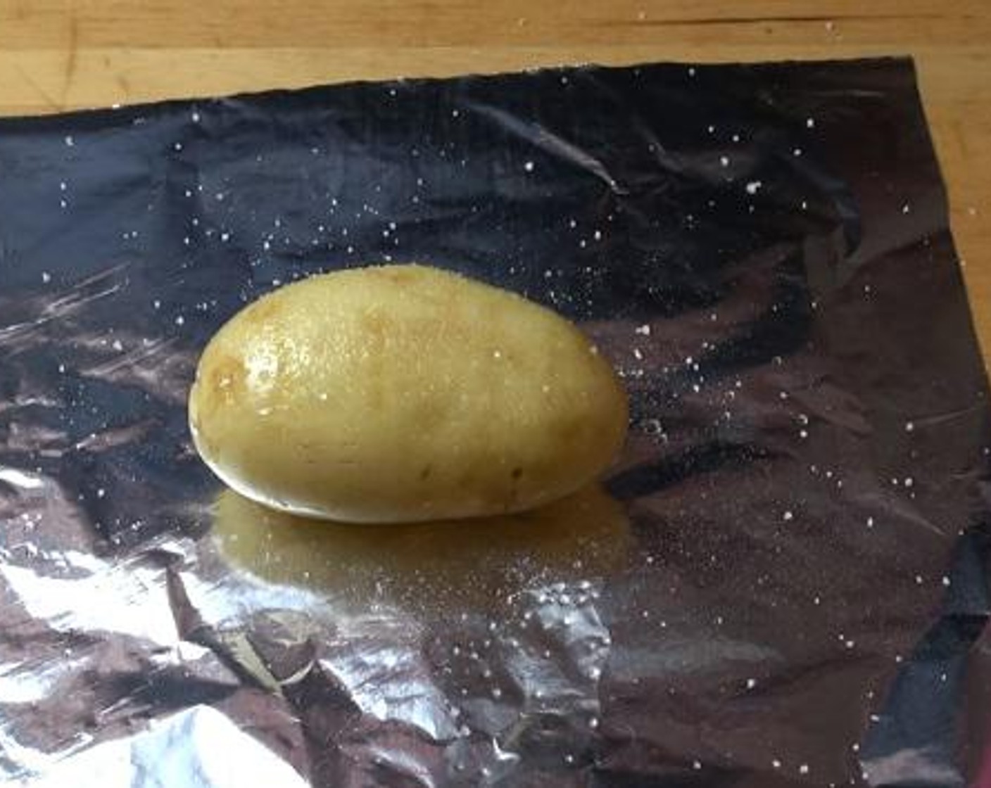 step 2 Brush each potato with some oil, and sprinkle over with some salt. Then wrap it up in a piece of foil nice and tight.