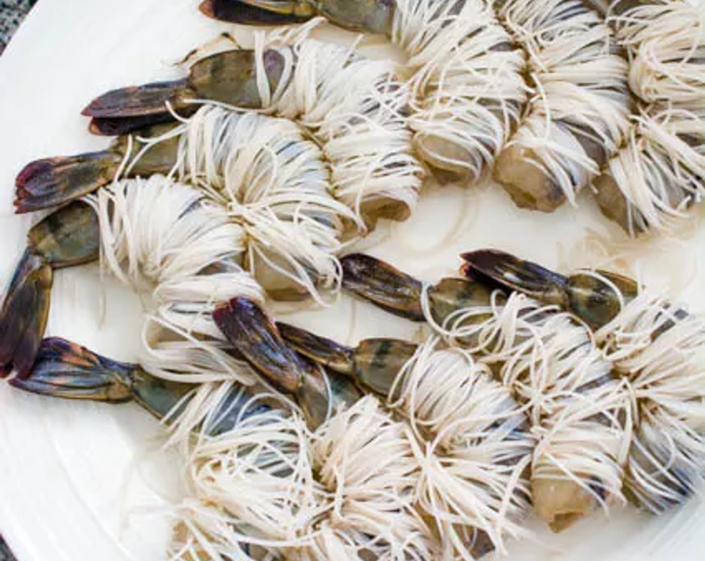 step 4 Wrap each shrimp in 7 to 8 strands (pinch a small amount) of vermicelli noodles.