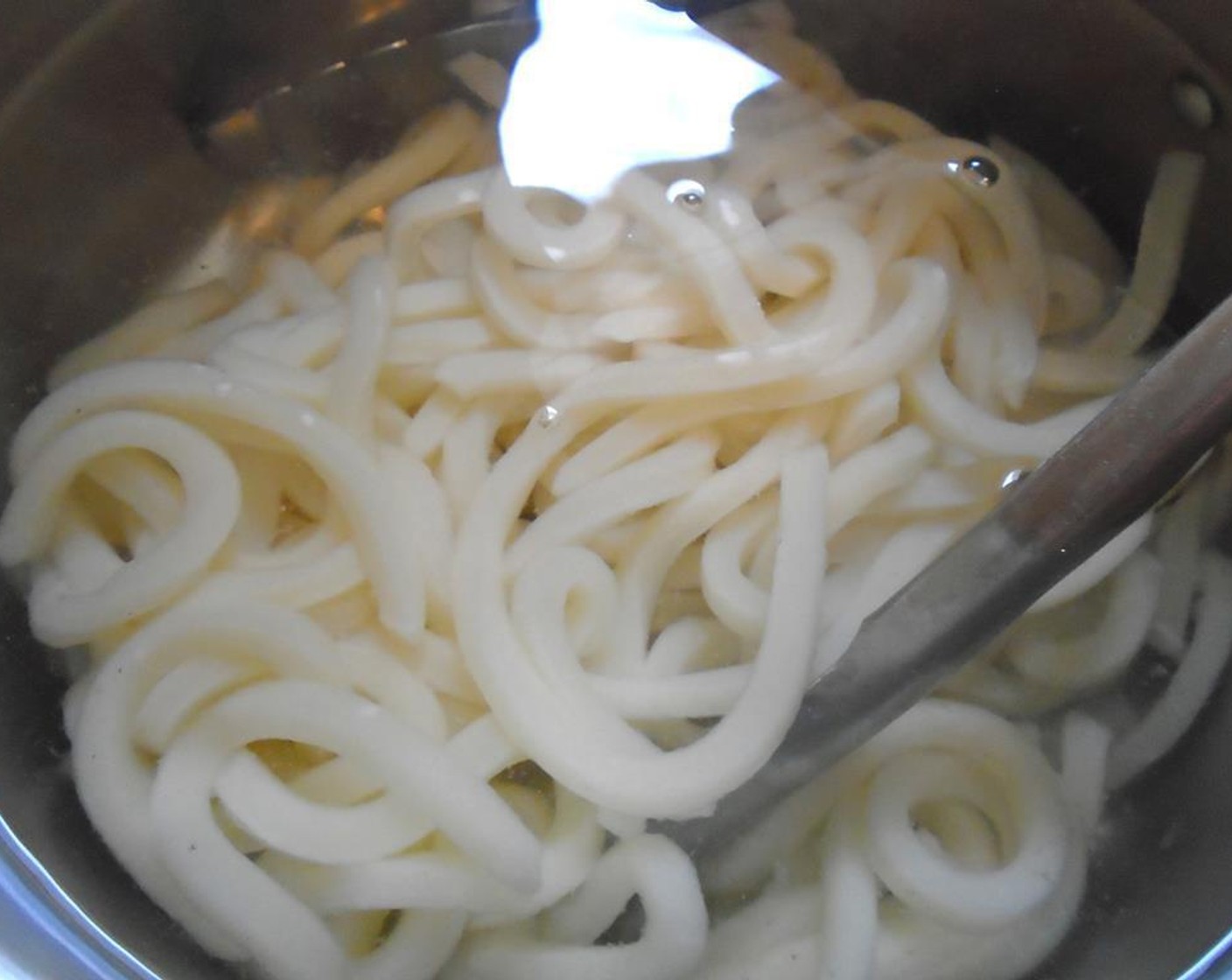 step 3 Simmer Udon Noodles (1 pckg) in salted water until cooked but still chewy, drain.