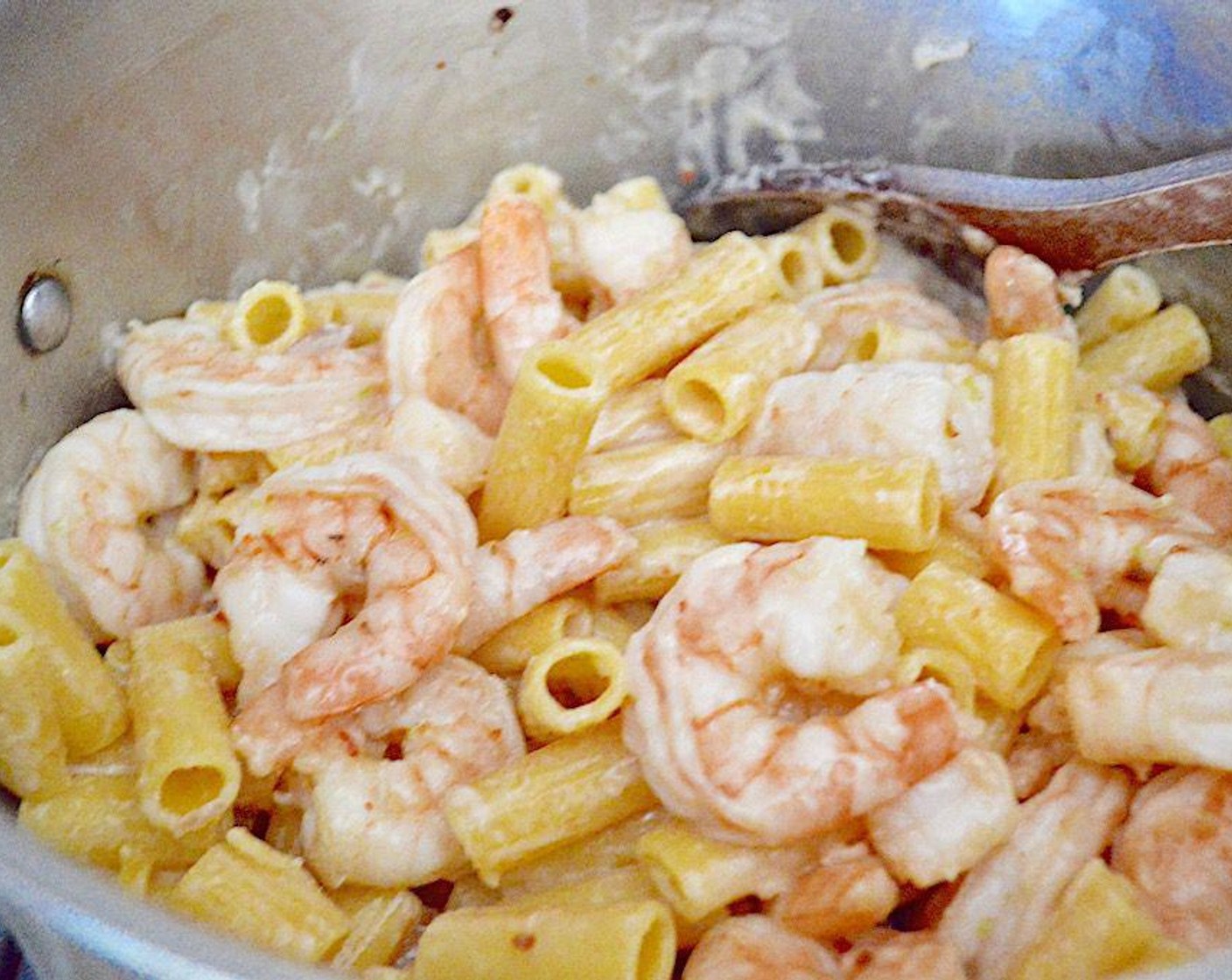 step 5 Once they're done, move the skillet off of the heat. The pasta should be done by the point. Drain it and return it to the pot it cooked in, then toss it with the sauce and shrimp.