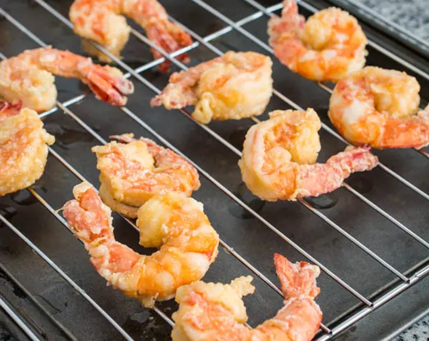 step 8 Place the fried shrimp on a cooling rack over a baking sheet, or on oil-absorbing paper.