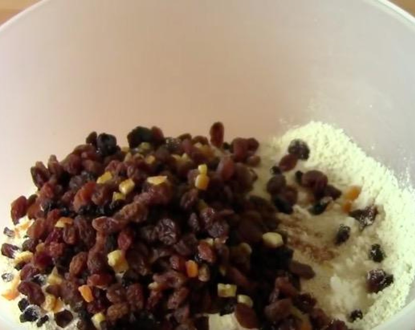 step 2 Add the All-Purpose Flour (4 cups), Caster Sugar (1/3 cup), Dry Mixed Spice (2 tsp), Instant Dry Yeast (2 tsp), Salt (1 pinch), and Dried Fruit Mix (1 1/4 cups) into a well and mix the ingredients all together until it's all combined.
