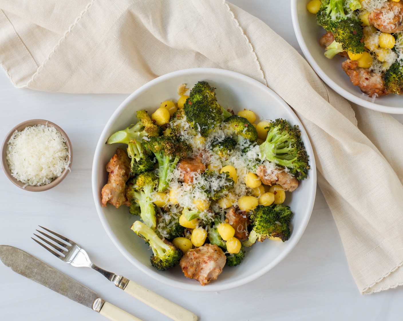 step 5 Divide the gnocchi, sausage, and broccoli among four dinner plates or pasta bowls. Garnish with Grated Parmesan Cheese (1/2 cup) and serve immediately.