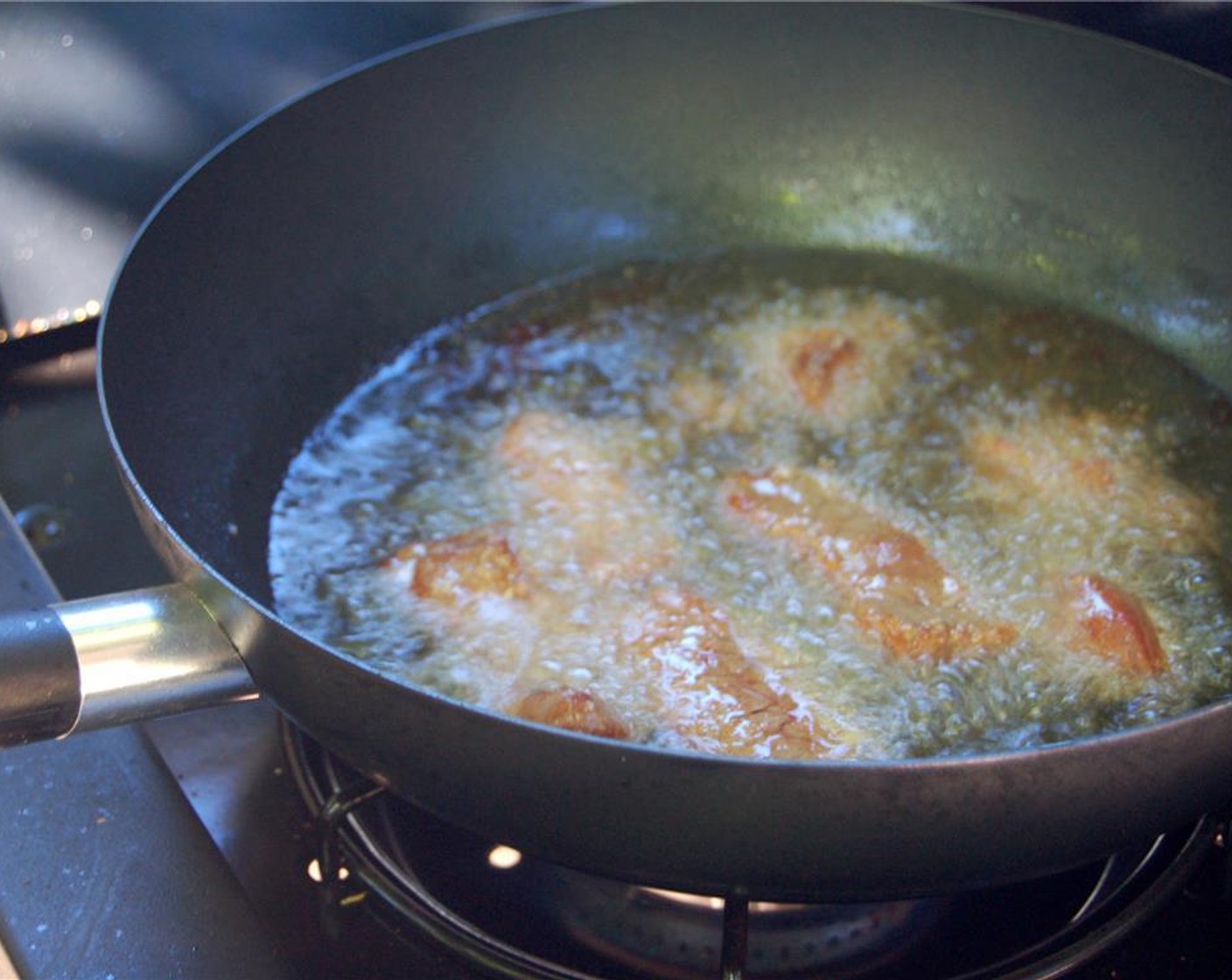 step 6 Heat Vegetable Oil (1 1/2 cups) in a wok or deep skillet over medium high heat. Fry the Thinly Sliced Sirloin in small batches until crispy and golden brown; set aside.