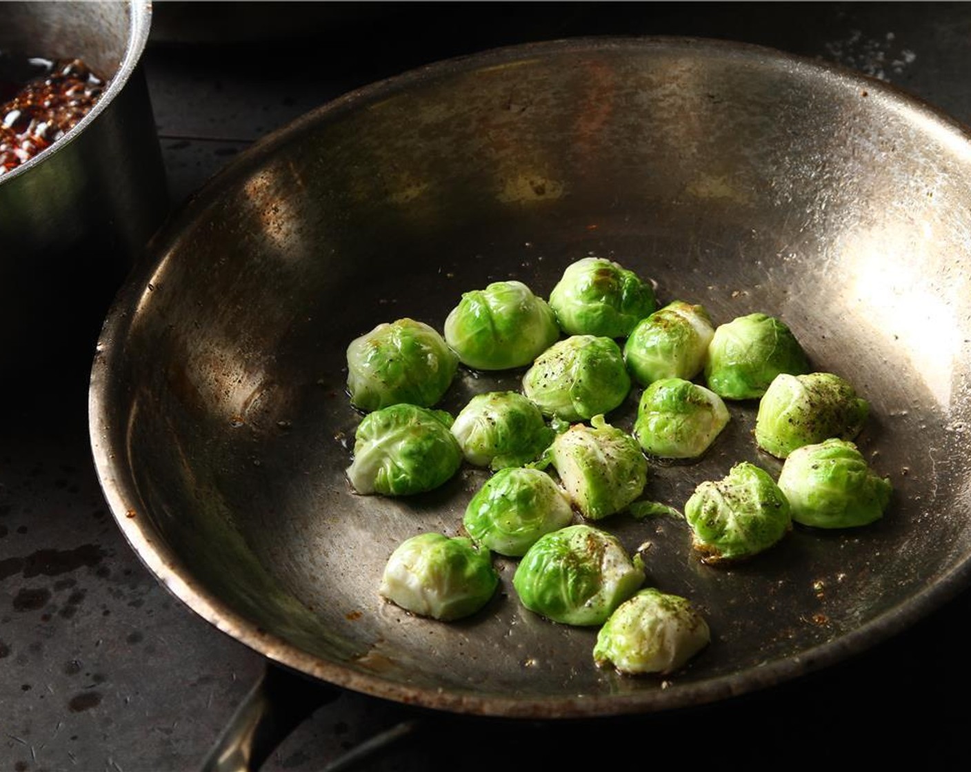 step 24 In a medium pan over medium heat add oil and place Brussels sprout cores, cut side down, into the pan, season aggressively with Salt (to taste) and Ground Black Pepper (to taste).