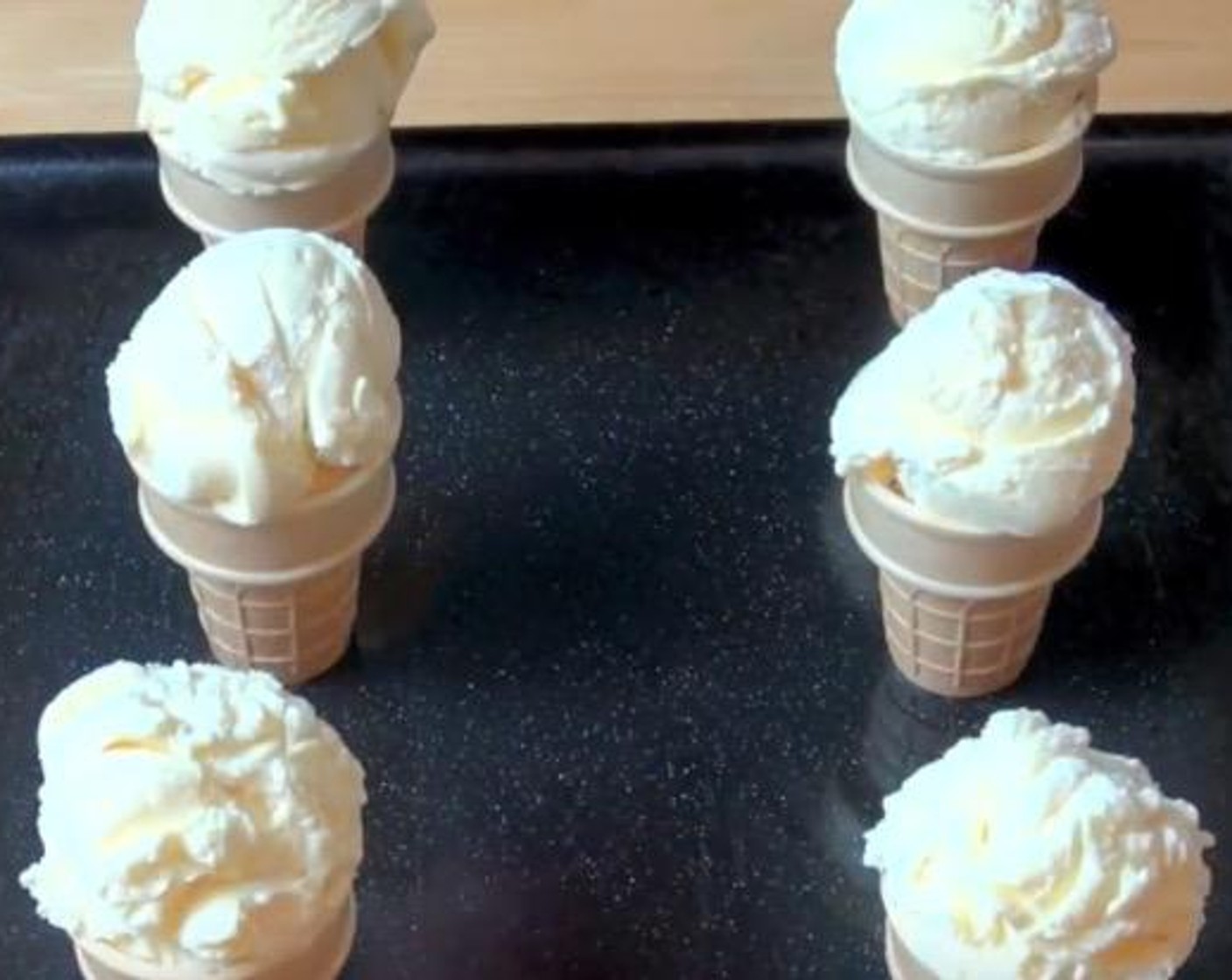 step 1 Scoop Ice Cream (5 3/4 cups) on top of each Flat-Bottomed Ice Cream Cones (12). Make sure the ice cream is fairly rounded on top. Put them in the freezer for about 15 to 20 minutes.