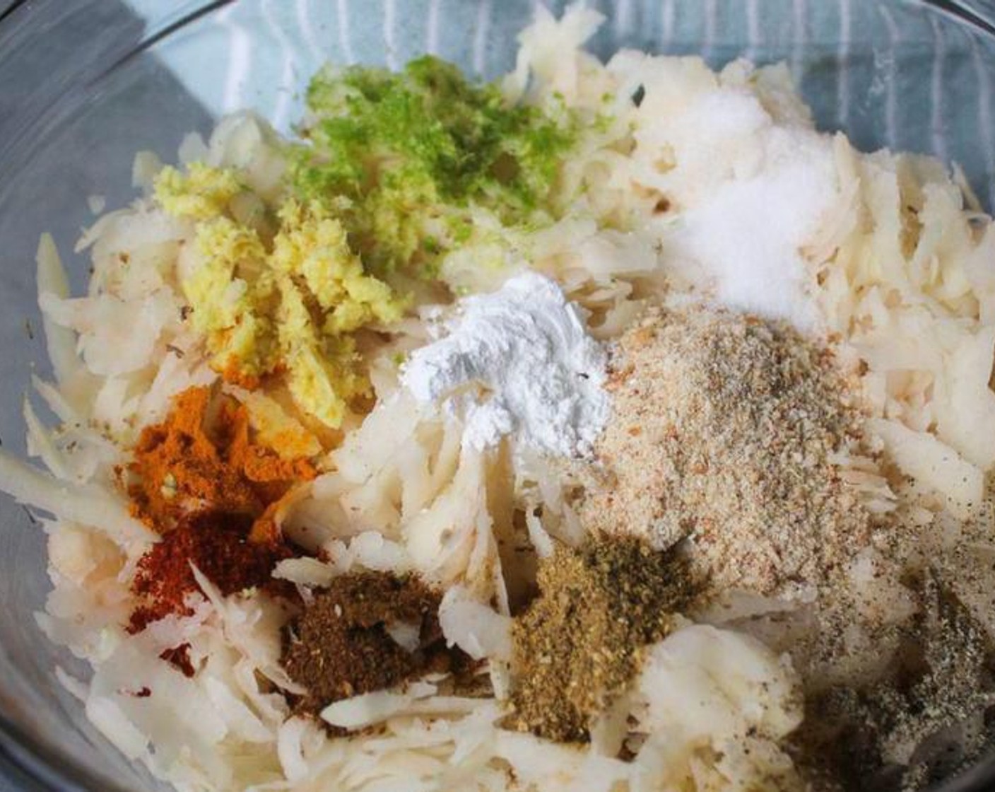 step 6 Add onion, ginger, green chili, Breadcrumbs (2 Tbsp), Ground Turmeric (1/2 tsp), Garam Masala (1/2 tsp), Ground Cumin (1/2 tsp), Ground Coriander (1/2 tsp), Salt (2 tsp), Ground Black Pepper (1/4 tsp), Chili Powder (1/4 tsp), Eggland's Best Classic Egg (1) and Chickpea Flour (4 Tbsp). Use your hands to mix until well incorporated.
