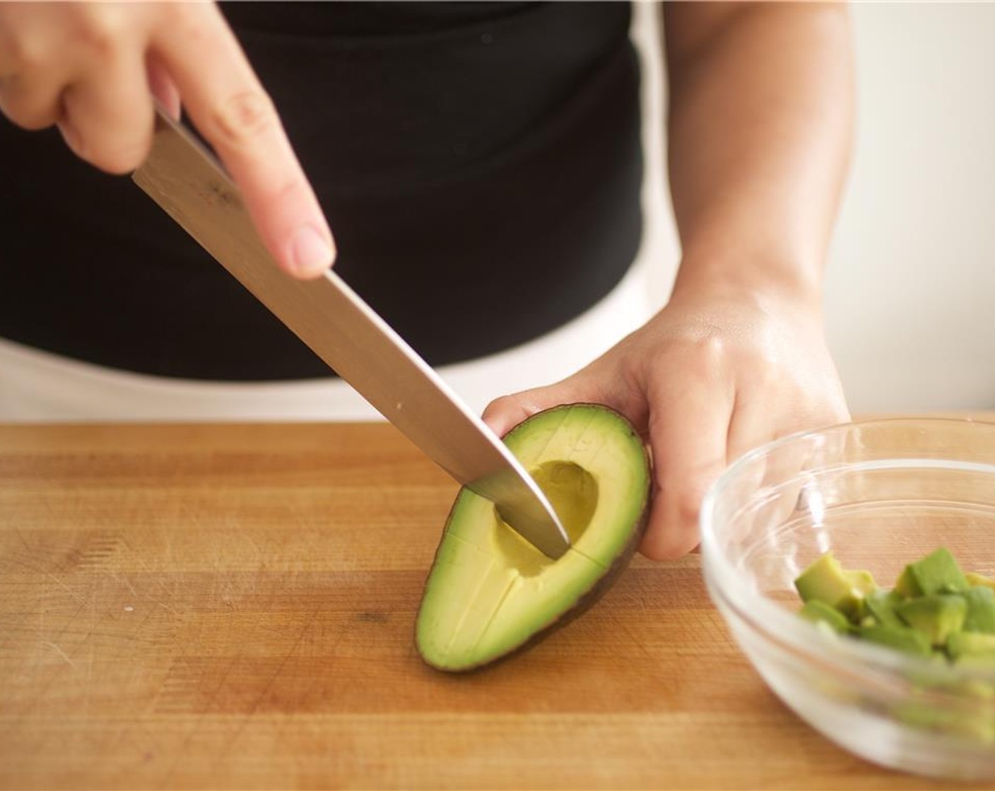 step 3 Slice through the Avocado (1) lengthwise around the pit and twist the two halves apart. Remove the pit by carefully whacking your knife into it and then twist the knife to pull out the pit.