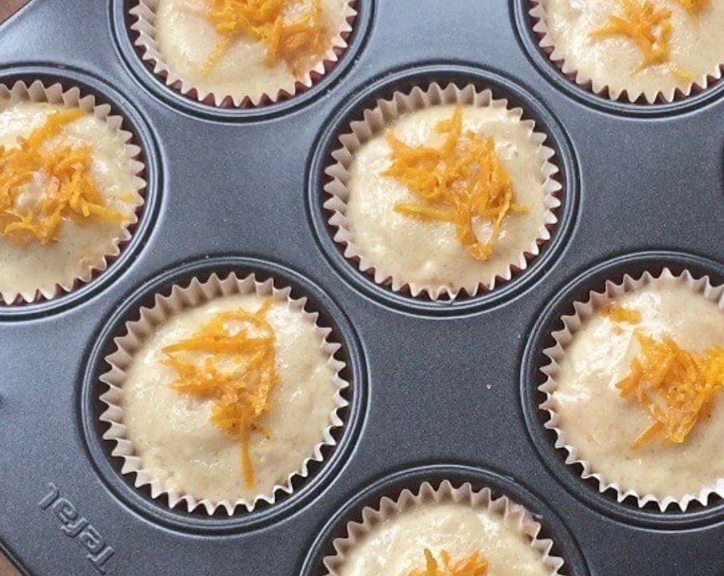 step 9 Sprinkle the top with Granulated Sugar (2 Tbsp) and garnish with orange rinds. And we're ready to bake the muffins.