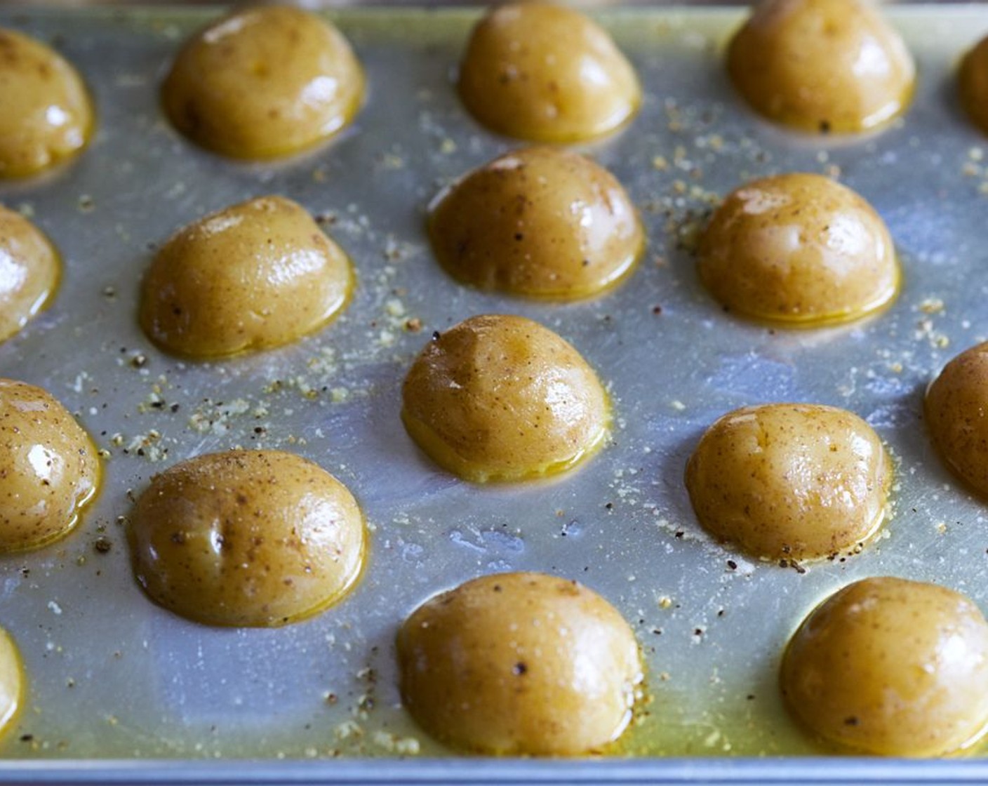 step 6 Drizzle Olive Oil (1/4 cup) all over the potatoes, season with Kosher Salt (to taste) and Freshly Ground Black Pepper (to taste), and toss to coat. Place them cut side down again, and return to the 500 degree F (260 degrees C) oven, uncovered, for 20-25 minutes.