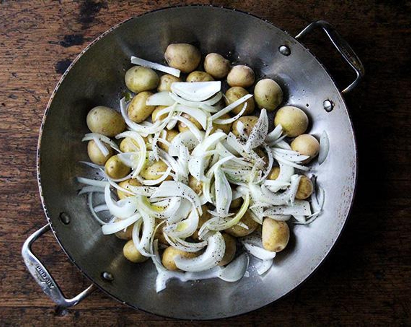 step 2 Place the Potatoes (1.5 lb), Onion (1), Olive Oil (2 Tbsp) and Water (1/2 cup) in a large oven-safe skillet. Season all over with Kosher Salt (to taste). Crack Ground Black Pepper (to taste) over top to taste. Toss to combine.