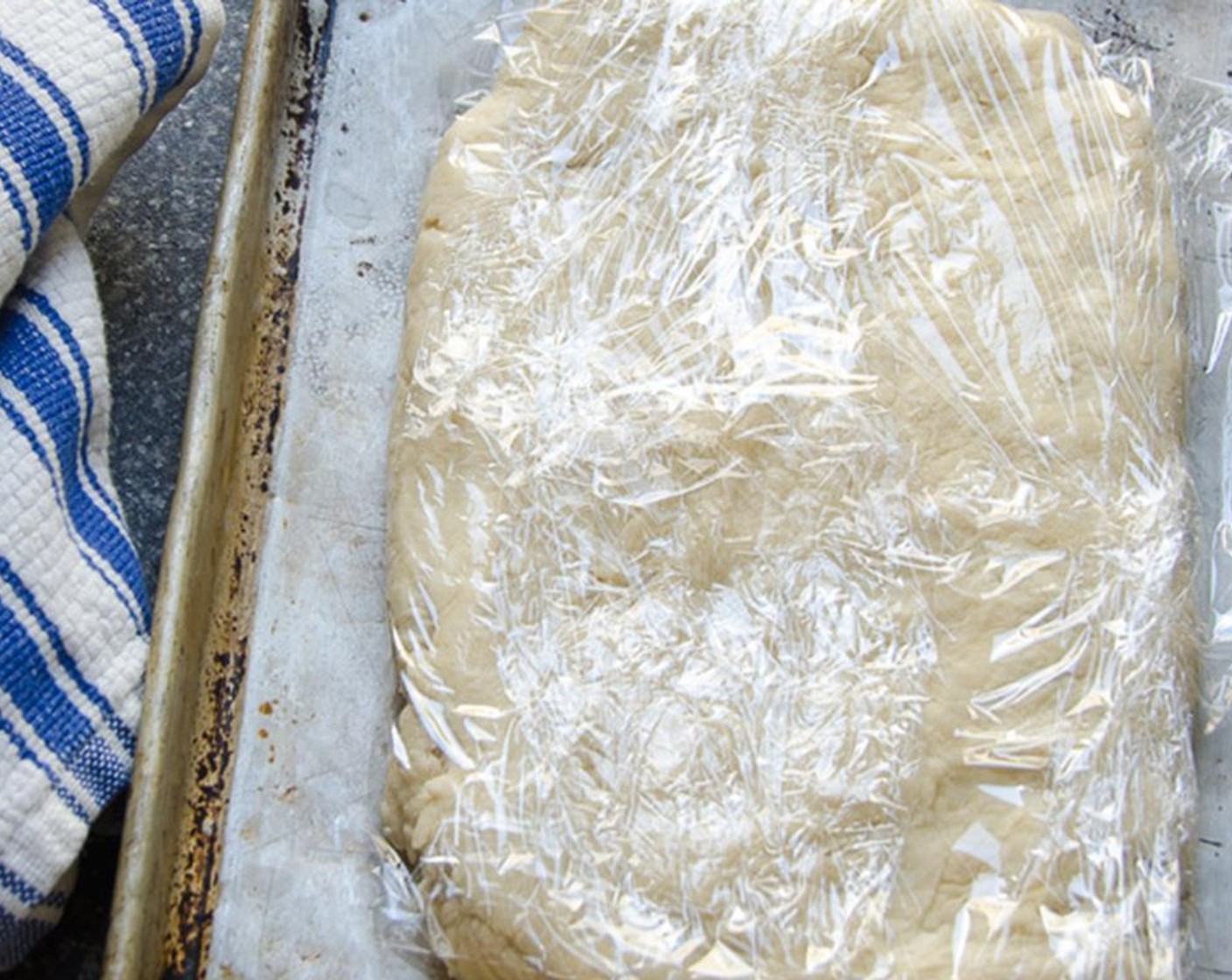 step 4 Turn out onto a lightly floured surface and gather the dough together. Knead gently once or twice, just enough to bring the dough together. Shape into a flat rectangle and chill, wrapped in plastic wrap for at least 1 hour.
