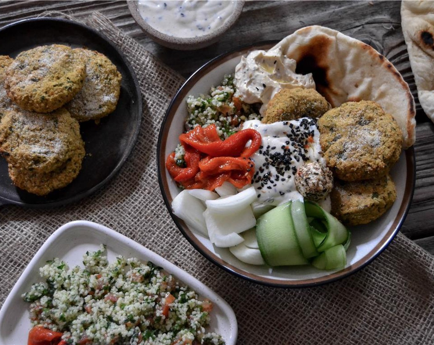 step 6 In a bowl, arrange the Tabouleh (to taste), along with Pickled Peppers (to taste), Fresh Herbs (to taste), cucumber ribbons, Onion (1), Labneh Cheese (to taste), and Flatbread (to taste) around a few of the falafels. Top with a dollop of Hummus (to taste).