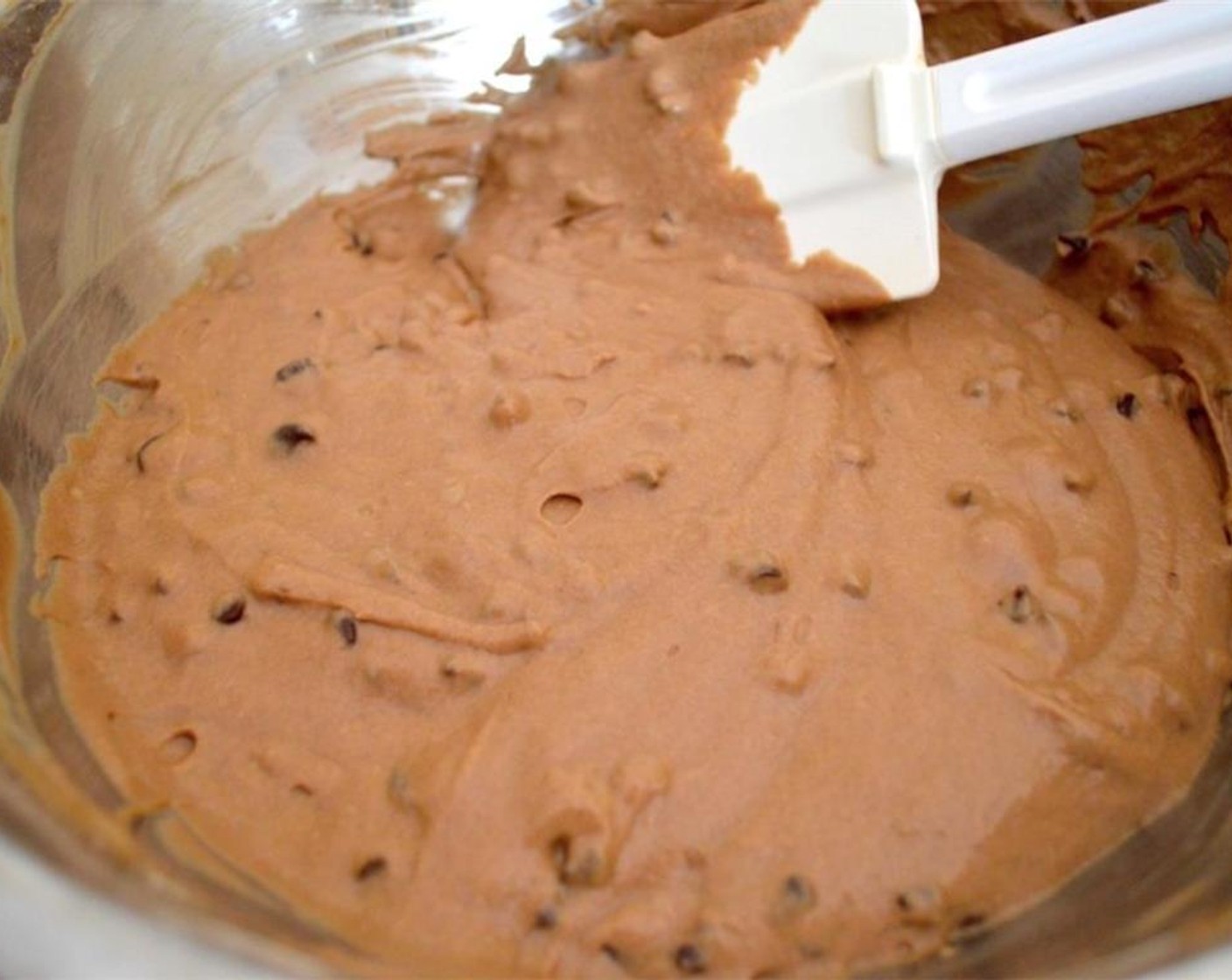 step 5 Pour the wet ingredients into the dry ingredients and whisk it all together just until a batter forms. Switch to a rubber spatula and fold in the Chocolate Chips (1 cup).