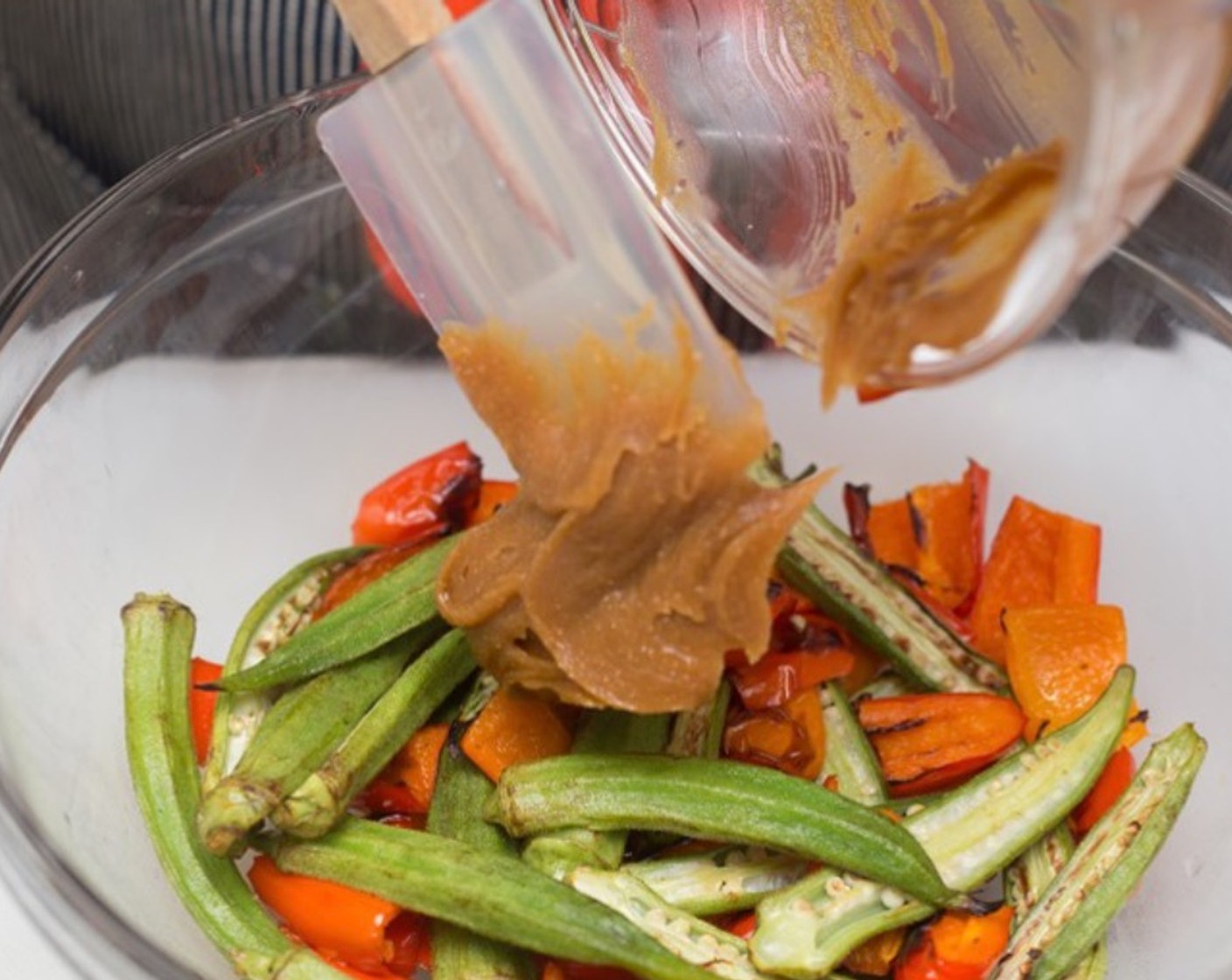 step 10 Remove vegetables from the oven, and return to the reserved mixing bowl. Add peanut vinaigrette, and mix thoroughly. Taste and adjust seasoning as desired.