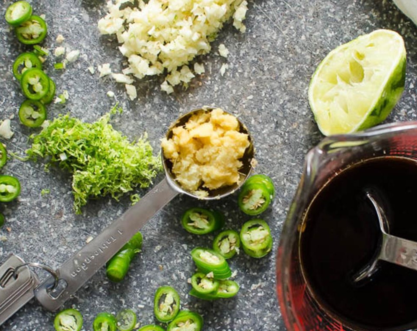step 2 In a small bowl or measuring cup, combine the Fresh Ginger (1 Tbsp), Garlic (2 cloves), 2 teaspoon of Lime Zest, 1 tablespoon of Lime Juice, Rice Vinegar (1 Tbsp), Low-Sodium Soy Sauce (4 Tbsp), Olive Oil (1 Tbsp), Fish Sauce (1 1/2 Tbsp), Brown Sugar (2 Tbsp), and Serrano Chilis (2).