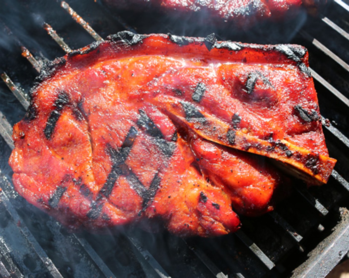 step 7 Remove the raised rack from the grill and place steaks directly on grill grate to sear each side, for about 4 minutes each side.