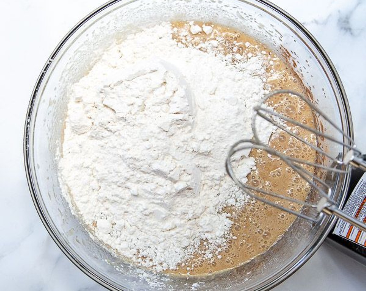 step 3 In a large bowl beat together Eggland's Best Classic Eggs (3), Vegetable Oil (1 cup), Vanilla Extract (2 tsp) and Granulated Sugar (2 cups) until very well combined. Add Salt (1 tsp), Baking Powder (1 tsp), Baking Soda (1/4 tsp) and Simply Organic Cinnamon, Ground (1 Tbsp). Beat well. Add All-Purpose Flour (3 cups) and mix until just combined.