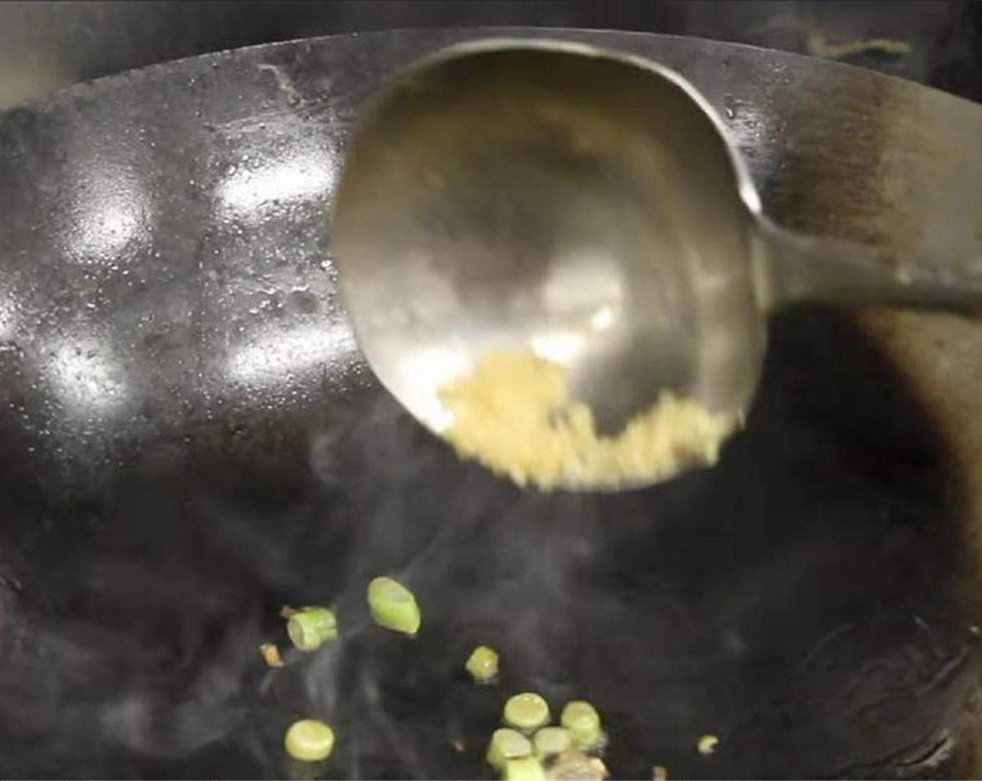 step 9 Turn fire to medium and add some Vegetable Oil (as needed) to the pan or wok. Add the minced garlic, and the white part of the green onion and cook until fragrant.