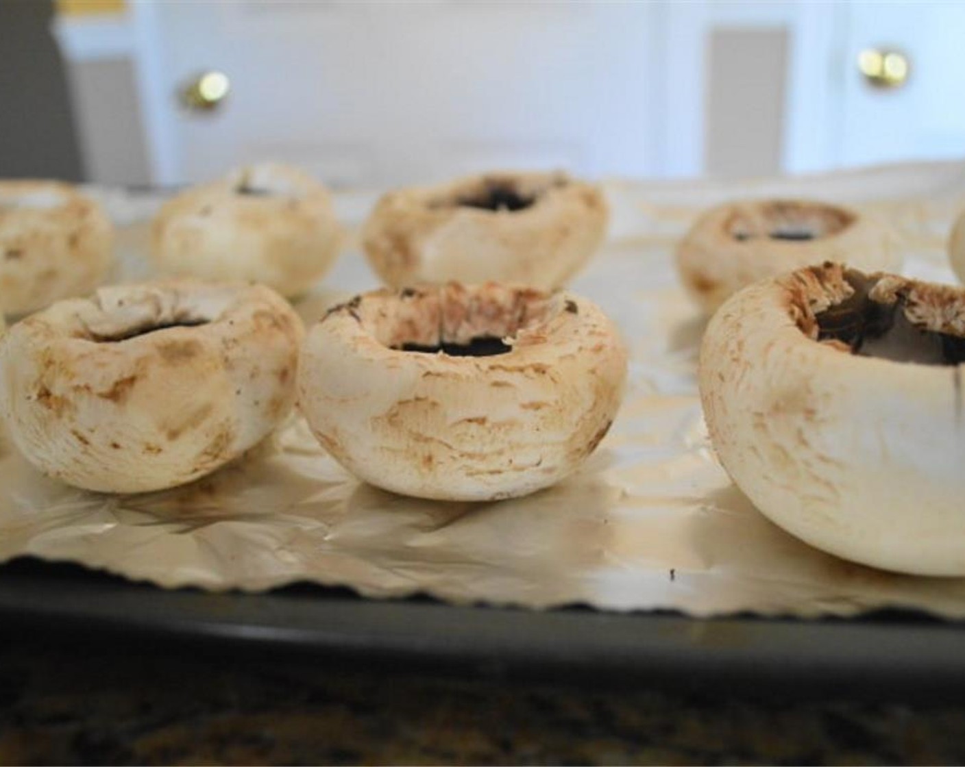 step 2 Wipe down each White Mushrooms (24) with a damp paper towel to clean them off, do not rinse them off because it will make them waterlogged​ and soggy. Remove the stems to have a nice hollowed out place for the stuffing.