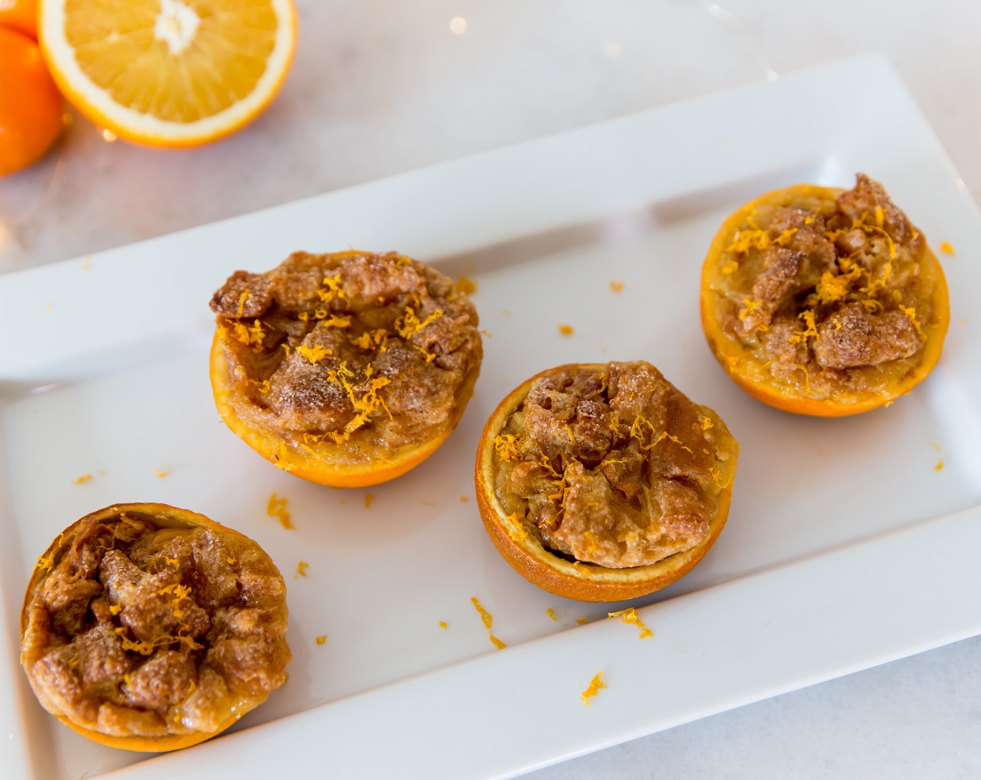 step 4 Carefully scoop croissant mixture and fill orange halves. Sprinkle with Simply Organic Cinnamon, Ground (2 tsp) and Granulated Sugar (4 Tbsp). Bake for 30 minutes or until cooked through, being careful not to burn. If bread puddings start to brown early, cover with foil and continue baking.
