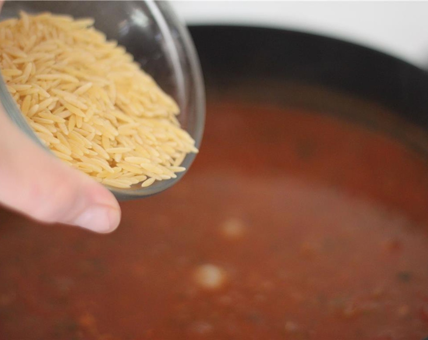 step 8 Thicken the soup by adding Tomato Paste (2 Tbsp), Canned Chickpeas (1/2 cup), Orzo Pasta (1/3 cup), and All-Purpose Flour (1/4 cup). Pour it in slowly as you stir the pot.