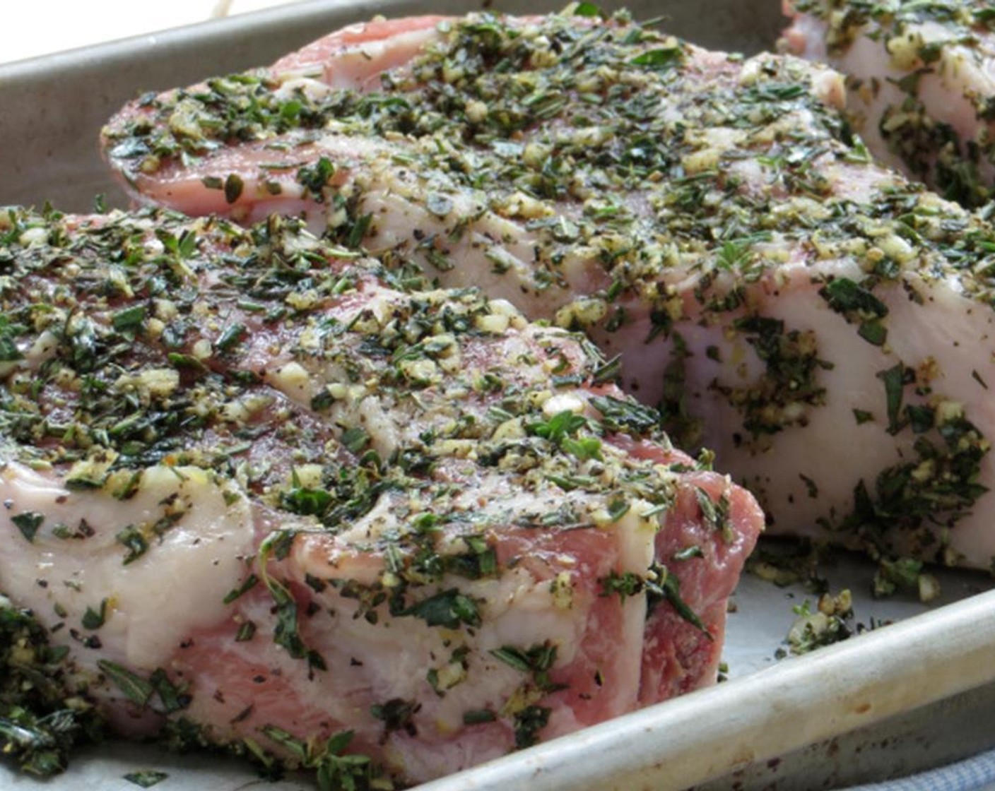 step 2 Place Veal Chops (2 lb) on a baking pan. Drizzle half the Olive Oil (1 Tbsp) over them. Sprinkle chops with half the herb mixture. Press herbs into the meat with your fingers, making sure they coat the chops. Turn chops over and repeat.