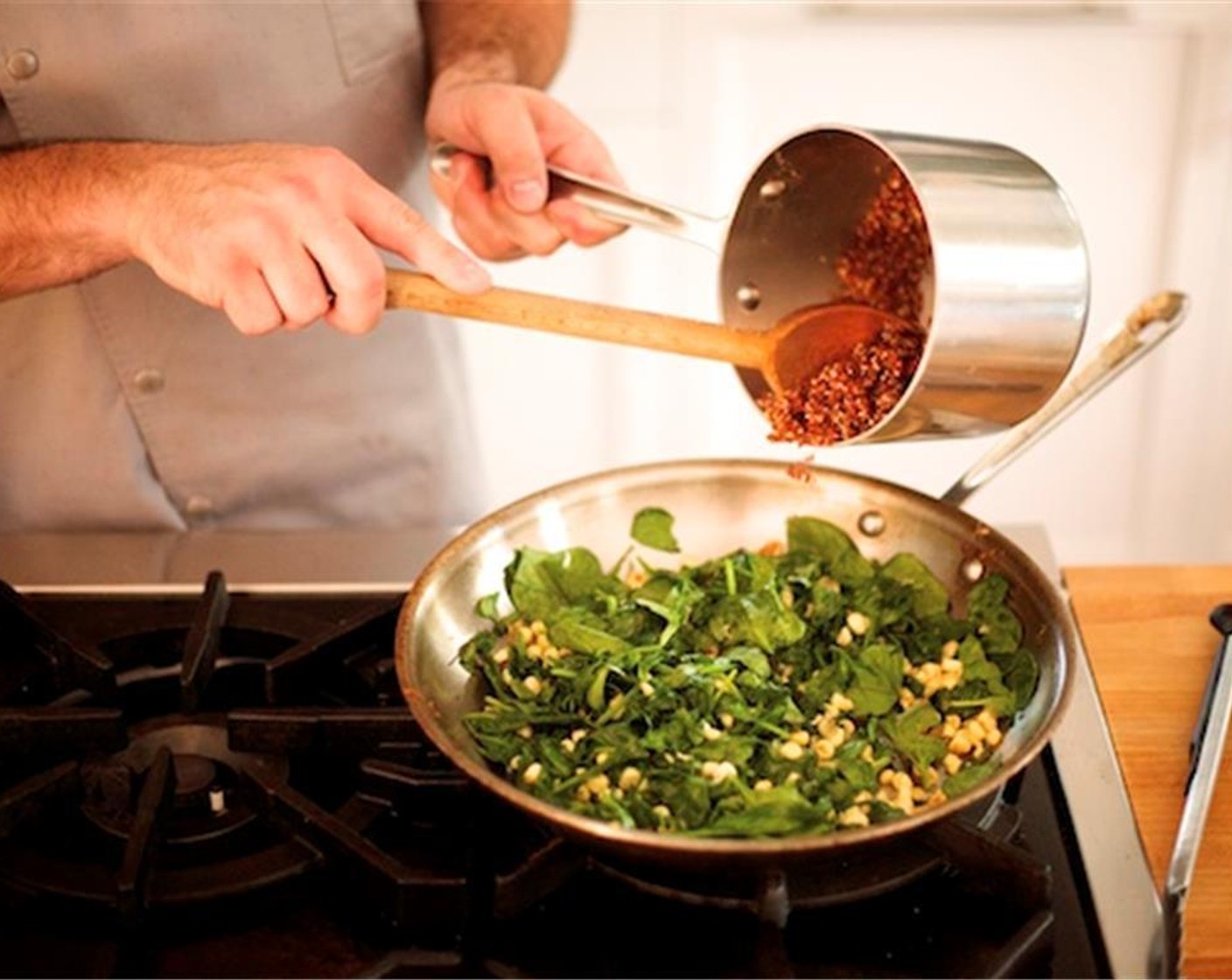 step 17 Remove the spinach from the heat. Stir in the cooked quinoa. Add the basil, mint, and lemon juice. Stir until well combined.