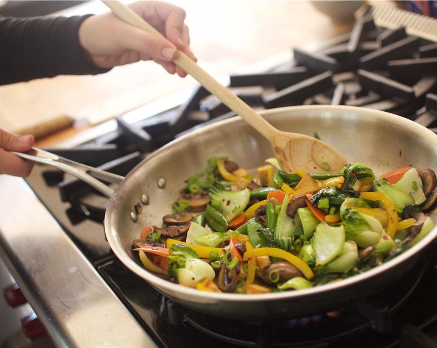 step 10 To the saute pan add the baby bok choy, Sugar Snap Peas (2/3 cup) ginger, garlic, and Crushed Red Pepper Flakes (1/4 tsp). Cook for three minutes, stirring constantly.