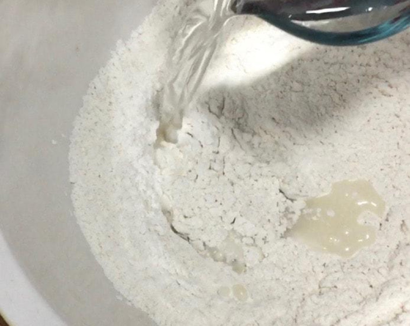 step 1 In a large mixing bowl, mix All-Purpose Flour (1 2/3 cups), Instant Dry Yeast (1 Tbsp) and Granulated Sugar (2/3 cup). Then, add in lukewarm Water (3/4 cup) and mix well.