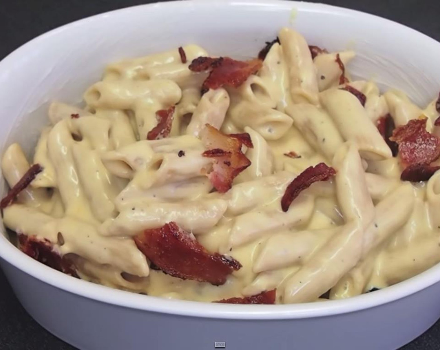 step 8 In a buttered dish, layer in pasta with crumbled bacon. Reserve some of the crumbled bacon for topping.