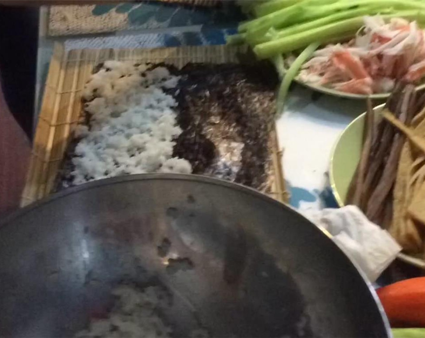 step 9 Lay out a Bamboo Rolling Mat on the table with one piece of the Nori Sheets (4) in front of you. Take about a cup of the rice and spread onto about 2/3 of the sheet, leaving a 3/4 border with no rice.