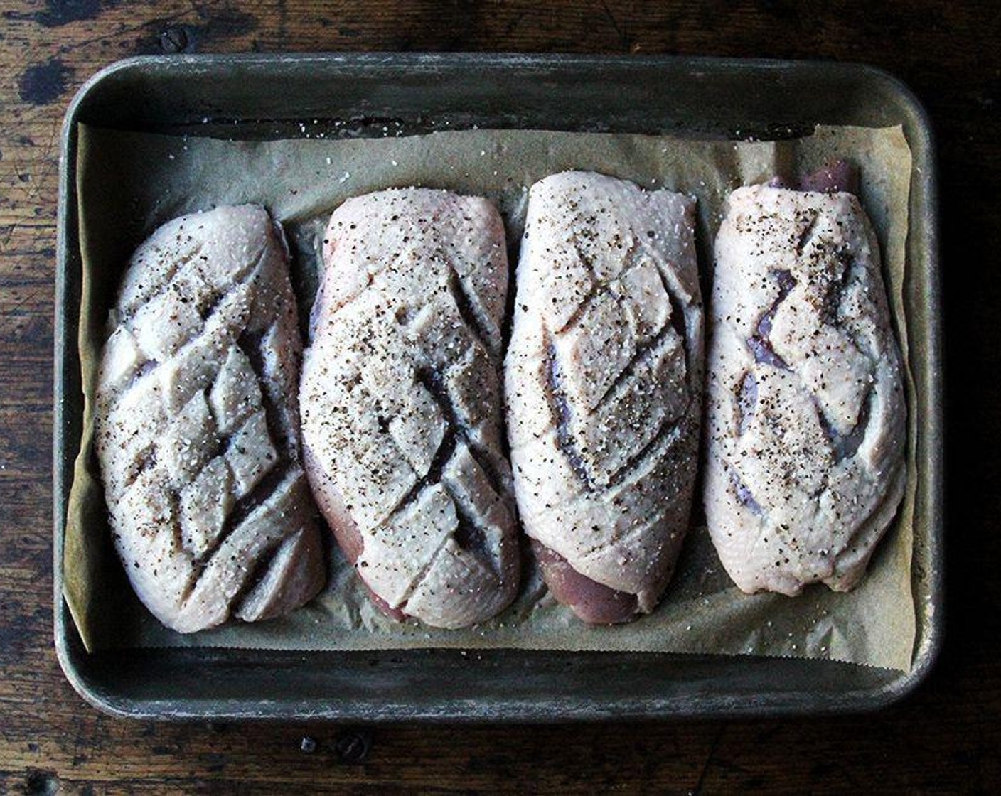 step 4 Blot the Skin-on Duck Breasts (4) dry. Use a sharp knife to score the fat of each in a diamond pattern, taking care not to cut into the meat. Season both sides of each breast generously with Kosher Salt (1 dash) and Freshly Ground Black Pepper (1 dash) then place them skin side down in a large, cold skillet.