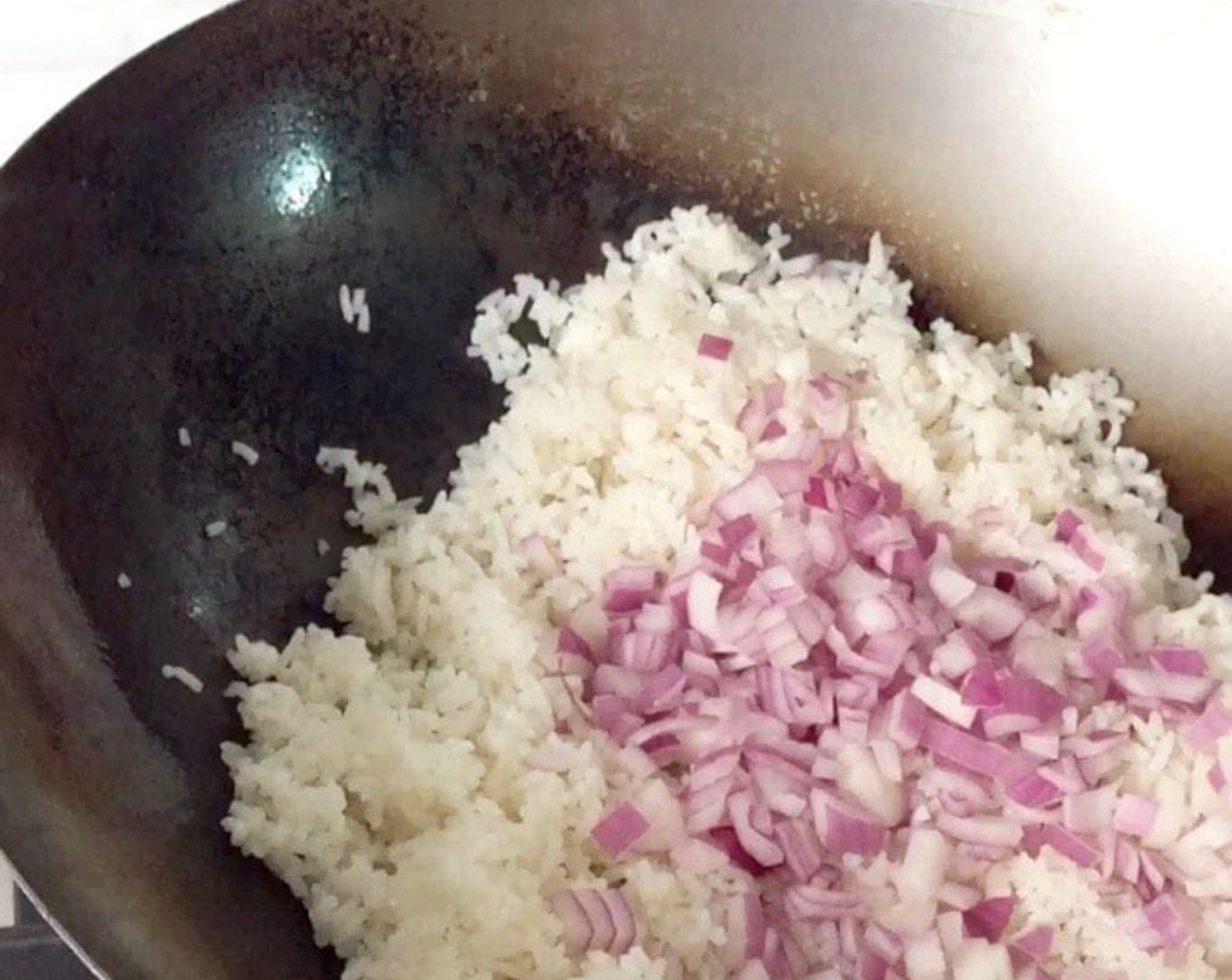 step 10 Next, add in the diced onions and continue to stir-fry, mixing well.