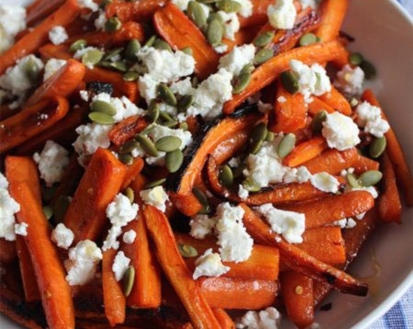step 6 To serve, place the carrots in a shallow serving dish. Top with the Goat Cheese (4 Tbsp), Pepitas (3 Tbsp), Honey (1 Tbsp), and a sprinkle of Salt (to taste) if desired. Serve warm or at room temperature.