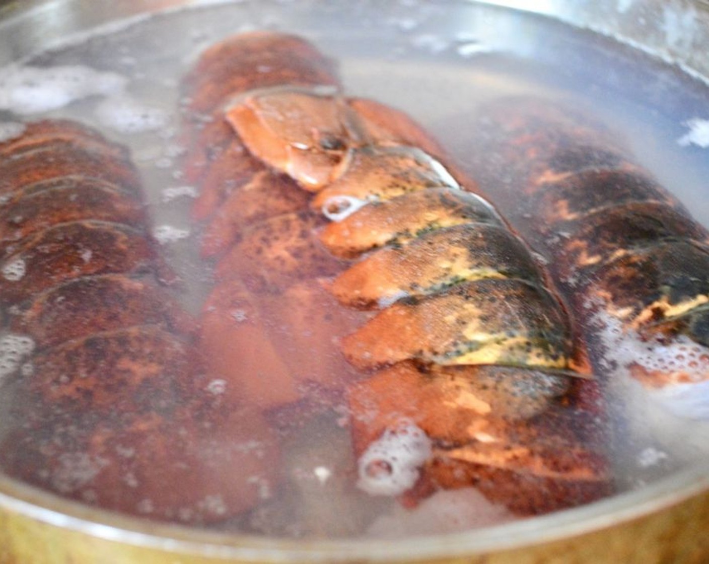 step 1 Fill a large skillet with deep sides with water about halfway and bring it to a boil on the stove. Salt it generously. Boil the Lobster Tails (4) in it for 8-9 minutes, until the shells turn a vivid red. Remove them and let them cool enough to handle.