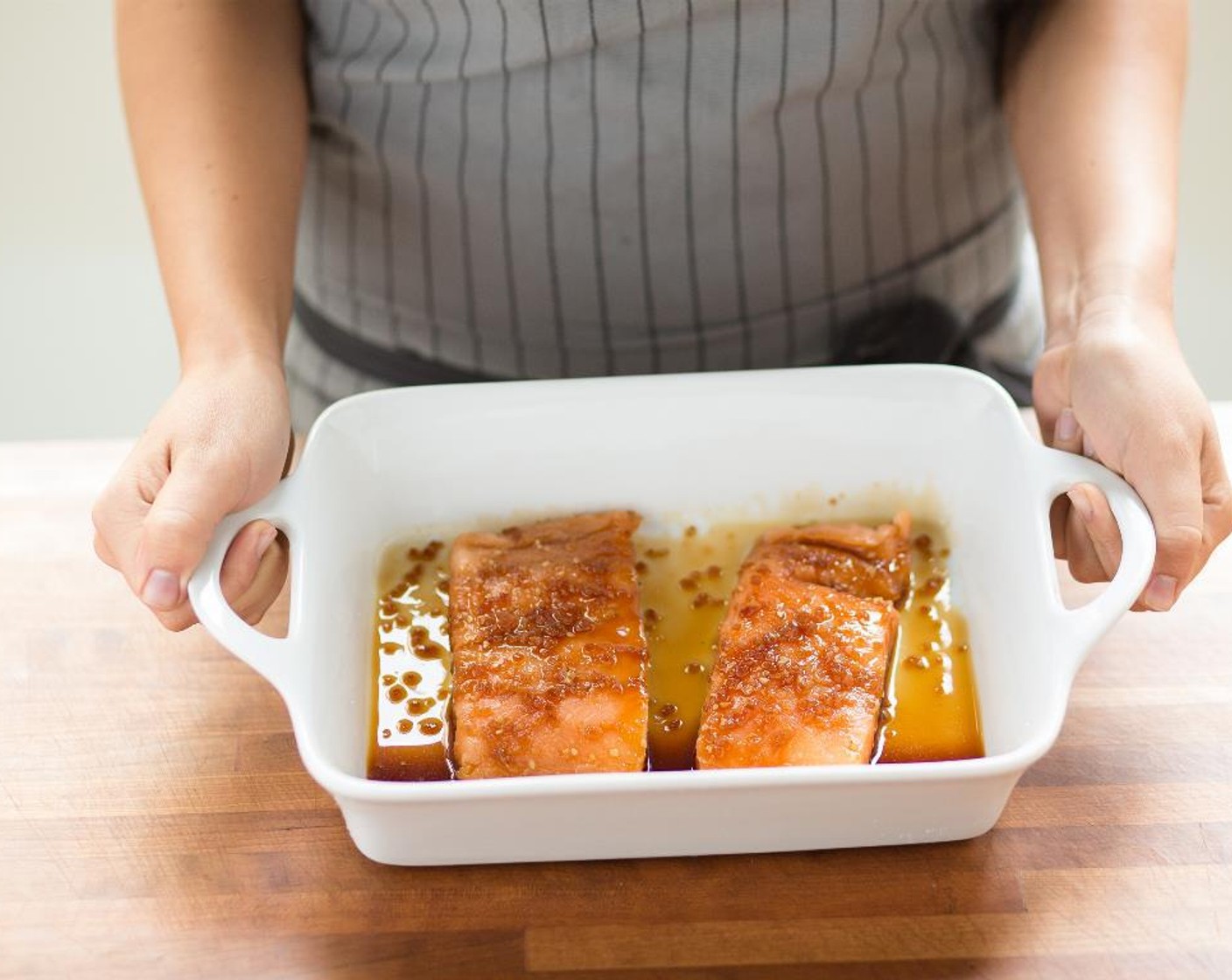 step 3 Place the salmon fillets in a baking dish and pour Teriyaki Sauce (1/2 cup) over the top and turn the fish until evenly coated. Cover with plastic wrap and place in the fridge until ready to use.