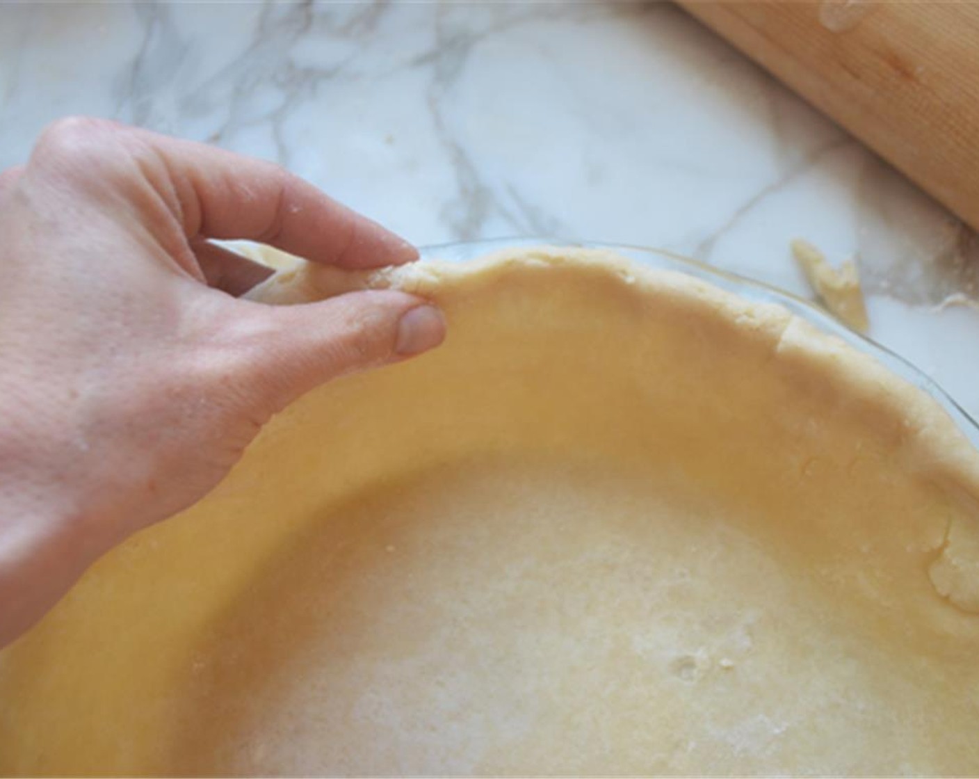 step 7 Trim the edges to 1/2 inch beyond the lip of the pie pan. Turn the edges under to create a rim on the crust then press the rim against the lip of the pan to form an even edge. Lastly, crimp the rim using your fingers.